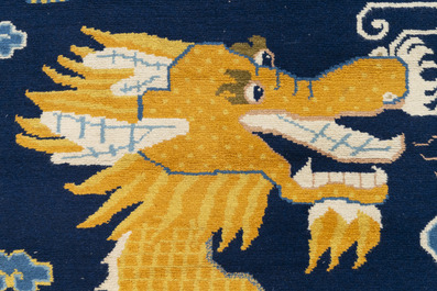 A Chinese woollen 'dragon' pillar carpet, 19th C.
