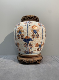 A pair of Chinese Imari-style 'grapevine' jars with wooden covers and stands, Kangxi