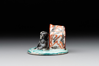 A rare polychrome Dutch Delft group of a dog in front of its doghouse, 18th C.