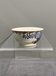 A Chinese gilt-decorated blue- and-puce-enamelled 'flower basket' cup and saucer, Qianlong