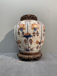 A pair of Chinese Imari-style 'grapevine' jars with wooden covers and stands, Kangxi