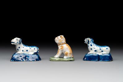 A pair of blue and white Dutch Delft miniature models of dogs and a polychrome dog, 18th C.