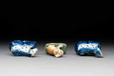 A pair of blue and white Dutch Delft miniature models of dogs and a polychrome dog, 18th C.