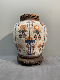 A pair of Chinese Imari-style 'grapevine' jars with wooden covers and stands, Kangxi