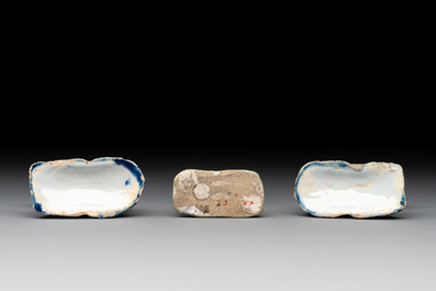 A pair of blue and white Dutch Delft miniature models of dogs and a polychrome dog, 18th C.