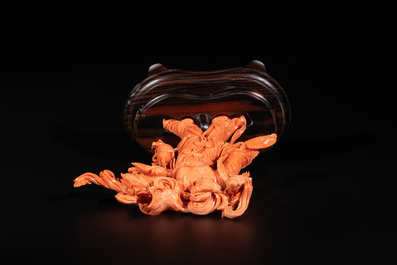 A Chinese red coral Xiwangmu on wooden stand, 19/20th C.