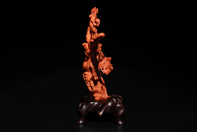 A Chinese red coral group of goddesses on wooden stand, 19/20th C.