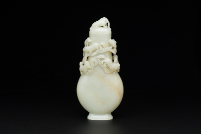 A fine Chinese white jade 'Buddhist lions' vase and cover, Qing