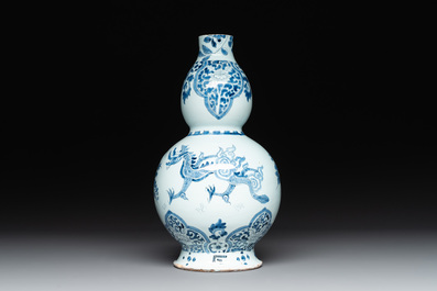 A pair of blue and white Dutch Delft fleur-de-lys-shaped 'Chinese dragon' dishes and a double gourd vase, 17/18th C.