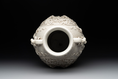 A Chinese white-glazed biscuit 'hu' vase with dragons, Qianlong mark, 19/20th C.