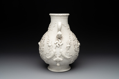 A Chinese white-glazed biscuit 'hu' vase with dragons, Qianlong mark, 19/20th C.