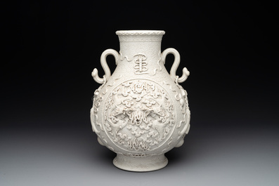 A Chinese white-glazed biscuit 'hu' vase with dragons, Qianlong mark, 19/20th C.
