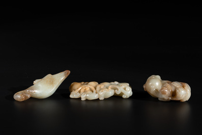 Three Chinese celadon and russet jade carvings of animals, 19th C.