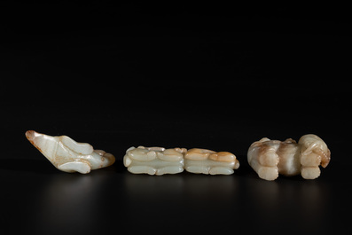 Three Chinese celadon and russet jade carvings of animals, 19th C.