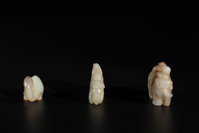 Three Chinese celadon and russet jade carvings of animals, 19th C.