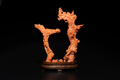 A Chinese pink-orange coral group of a goddess of spring, a wise man and children in a pine tree, 19/20th C.