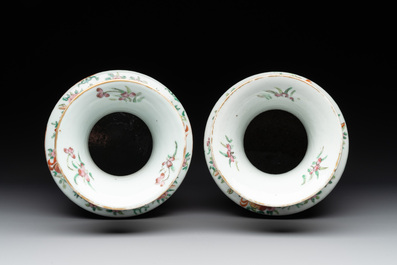 A pair of Chinese Canton famille rose vases and two plates, 19th C.