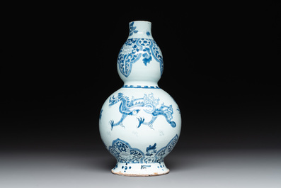 A pair of blue and white Dutch Delft fleur-de-lys-shaped 'Chinese dragon' dishes and a double gourd vase, 17/18th C.