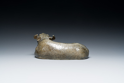 A Chinese brown-grey-glazed recumbent water buffalo on wooden stand, 19th C.