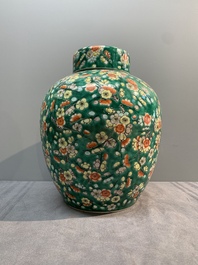A pair of Chinese famille verte green-ground 'prunus' jars and covers, 19th C.