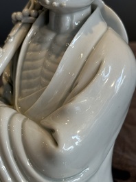 A Chinese Dehua blanc de Chine Luohan on wooden stand, 19/20th C.