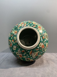 A pair of Chinese famille verte green-ground 'prunus' jars and covers, 19th C.
