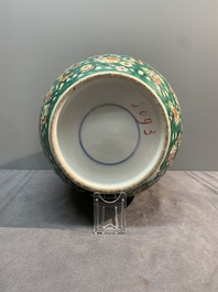 A pair of Chinese famille verte green-ground 'prunus' jars and covers, 19th C.
