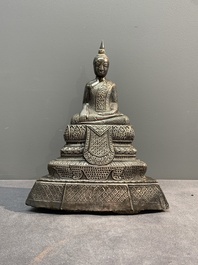 A Cambodian silver repouss&eacute; Buddha with inscription, 19th C.