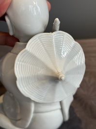 A Chinese Dehua blanc de Chine Luohan on wooden stand, 19/20th C.