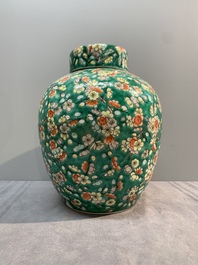 A pair of Chinese famille verte green-ground 'prunus' jars and covers, 19th C.
