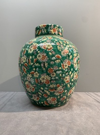 A pair of Chinese famille verte green-ground 'prunus' jars and covers, 19th C.