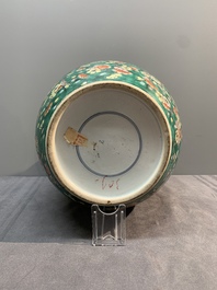 A pair of Chinese famille verte green-ground 'prunus' jars and covers, 19th C.