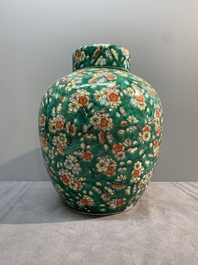 A pair of Chinese famille verte green-ground 'prunus' jars and covers, 19th C.