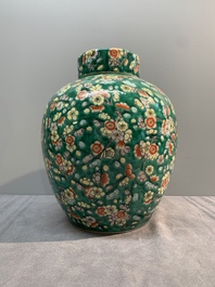 A pair of Chinese famille verte green-ground 'prunus' jars and covers, 19th C.