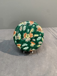A pair of Chinese famille verte green-ground 'prunus' jars and covers, 19th C.