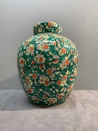 A pair of Chinese famille verte green-ground 'prunus' jars and covers, 19th C.