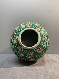 A pair of Chinese famille verte green-ground 'prunus' jars and covers, 19th C.