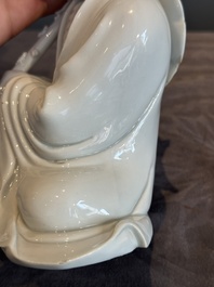 A Chinese Dehua blanc de Chine Luohan on wooden stand, 19/20th C.