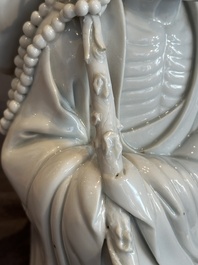 A Chinese Dehua blanc de Chine Luohan on wooden stand, 19/20th C.