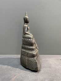 A Cambodian silver repouss&eacute; Buddha with inscription, 19th C.