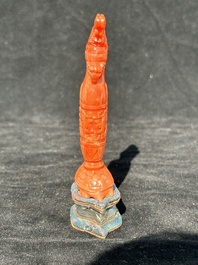 A Chinese carved red coral 'mythical animals' snuff bottle on stand, 19/20th C.