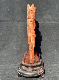 A Chinese red coral Xiwangmu on wooden stand, 19/20th C.