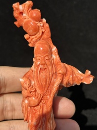 Two Chinese red coral figures of Shoulao on wooden stand, 19/20th C.