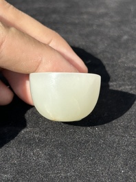 A Chinese white jade cup and two rings, Qing