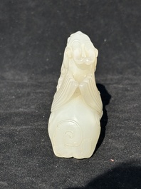 A Chinese white jade carving of a mythic animal, 19/20th C.