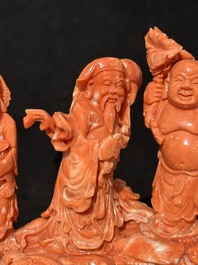 A Chinese red coral 'Sanxing' group on wooden stand, 19/20th C.