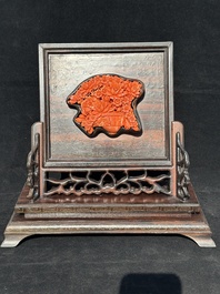 A Chinese silver-inlaid hardwood table screen with a red coral carving of a flower basket, 19/20th C.