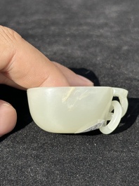 A Chinese white jade cup and two rings, Qing