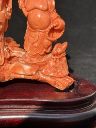 A Chinese red coral 'Sanxing' group on wooden stand, 19/20th C.