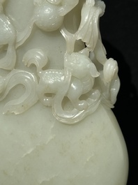 A fine Chinese white jade 'Buddhist lions' vase and cover, Qing